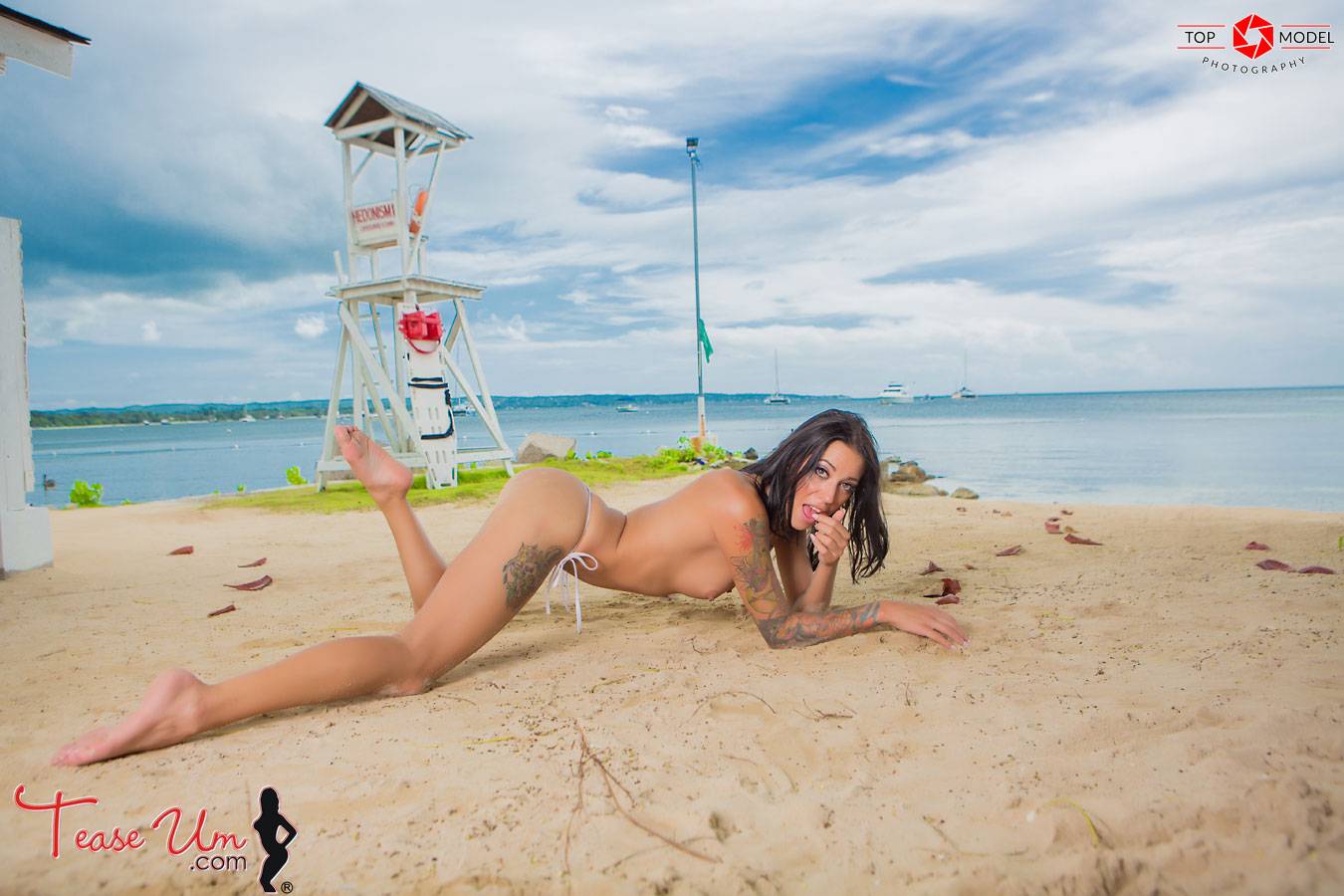 tattooed model naked on the beach thumb 2